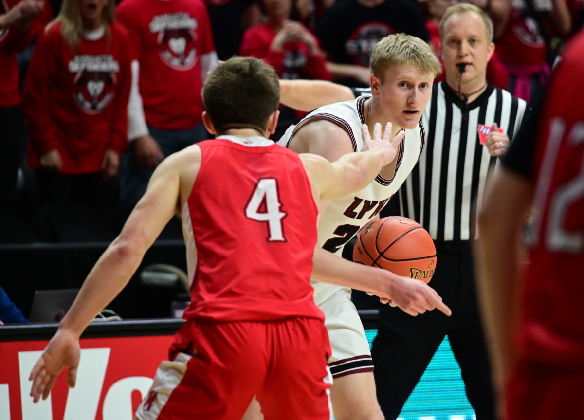North Linn's Ty Pfughaupt scans the court while being guarded by Bellevue Marquette's Caden Kettmann during the Class 1A state championship game at Wells Fargo Arena in Des Moines on Friday. (Photo by Ryan Timmerman)